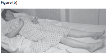 A person laying in bed with their legs crossed.
